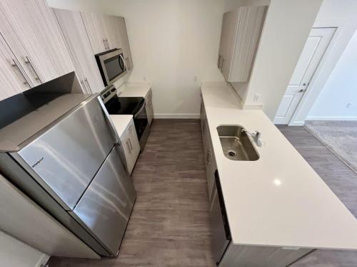 Studio Apartments in Ogden, UT - Stainless Appliances with Single Basin Sink and Quartz Countertops